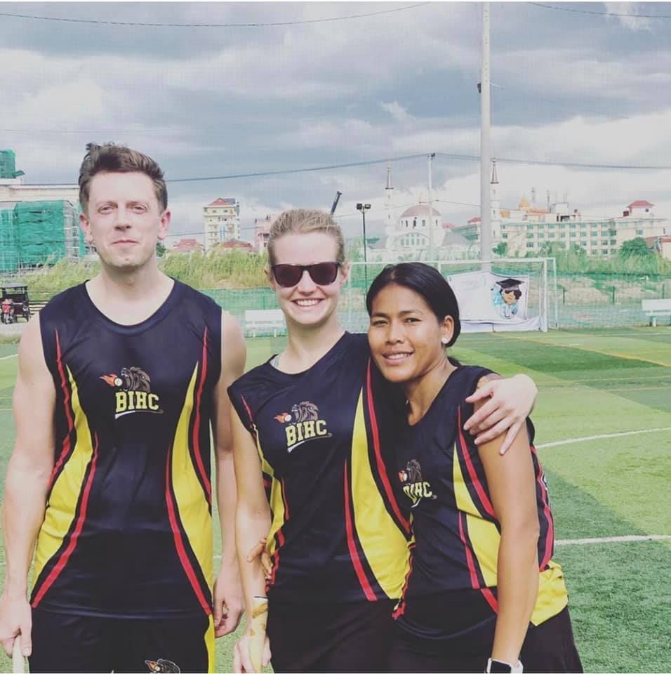 Three people posing for a picture wearing bibc shirts