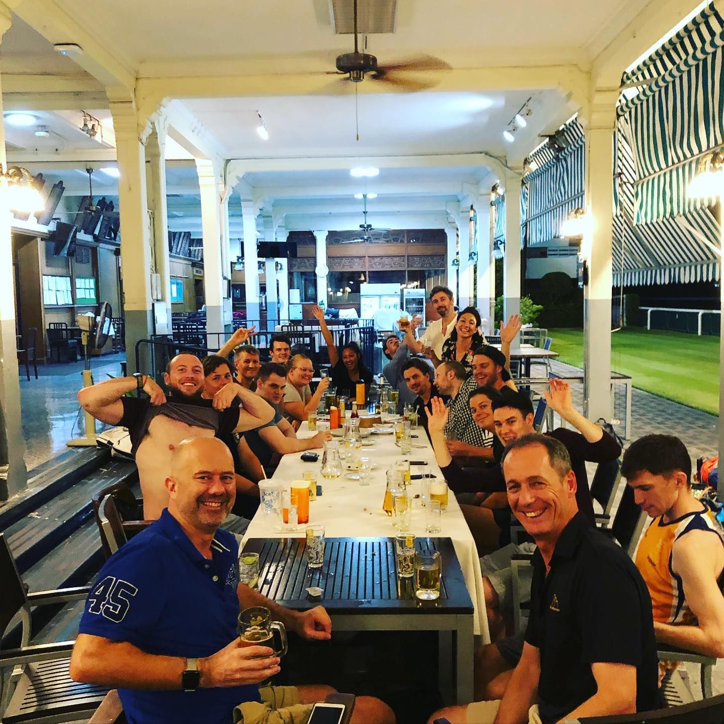 A group of men are sitting around a long table