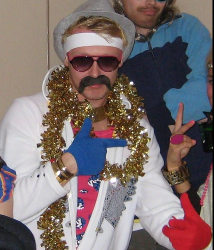 A man with a fake mustache wearing sunglasses and a cowboy hat