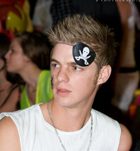 A man with a skull and crossbones eye patch on his forehead