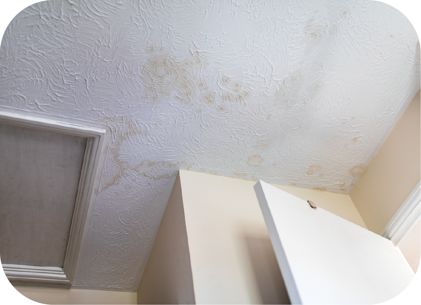 An attic with a pipe covered in aluminum foil