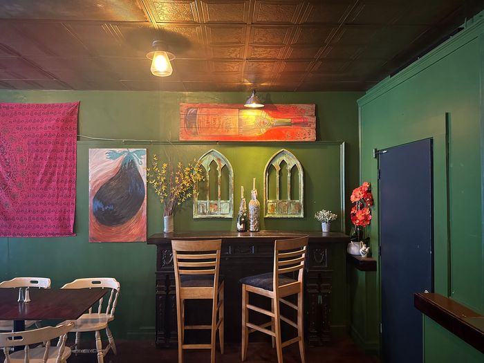 a dining room with green walls and tables and chairs