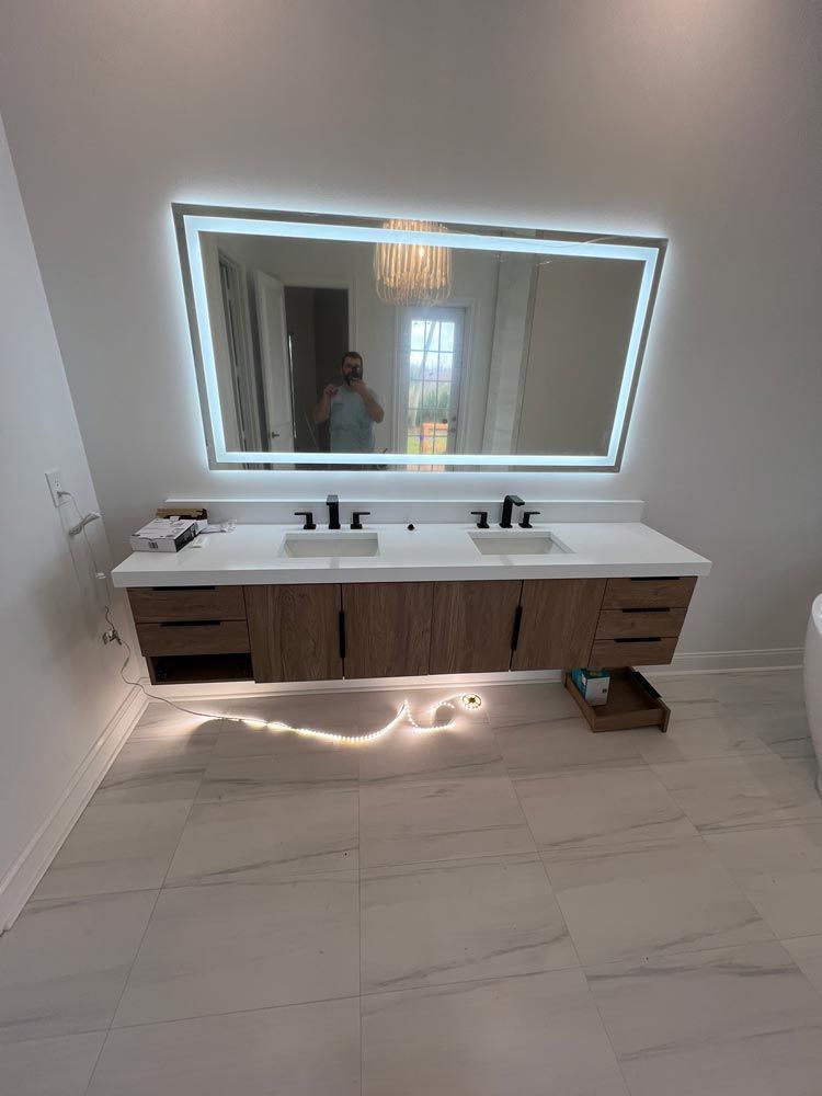 A bathroom with two sinks and a large mirror.