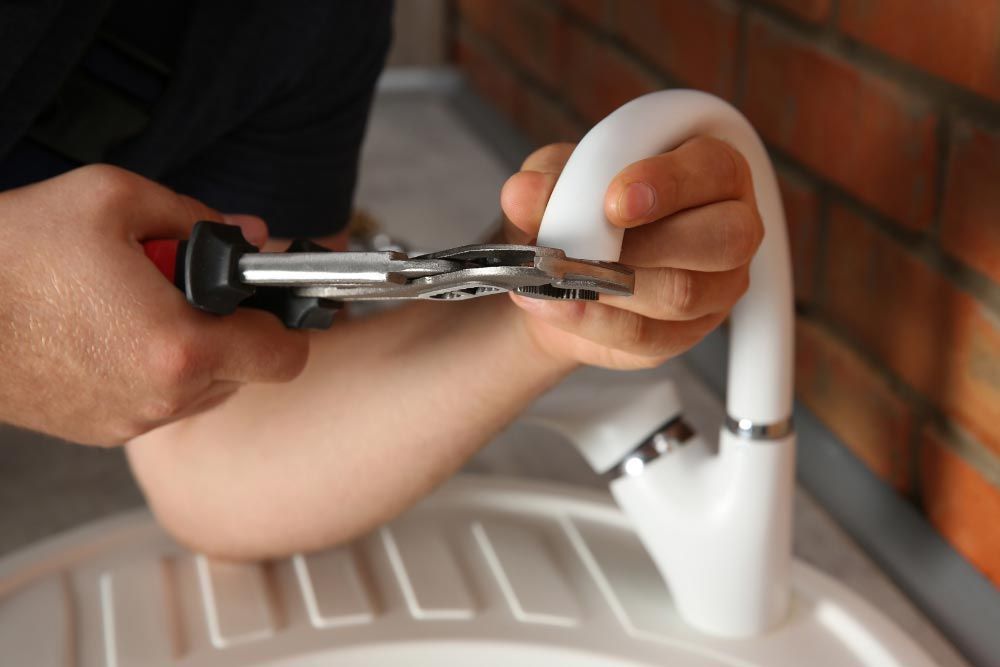 Plumber replacing faucet