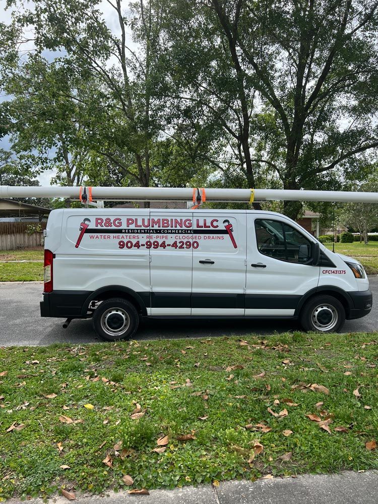 A white van with a pipe on the roof is parked on the side of the road.
