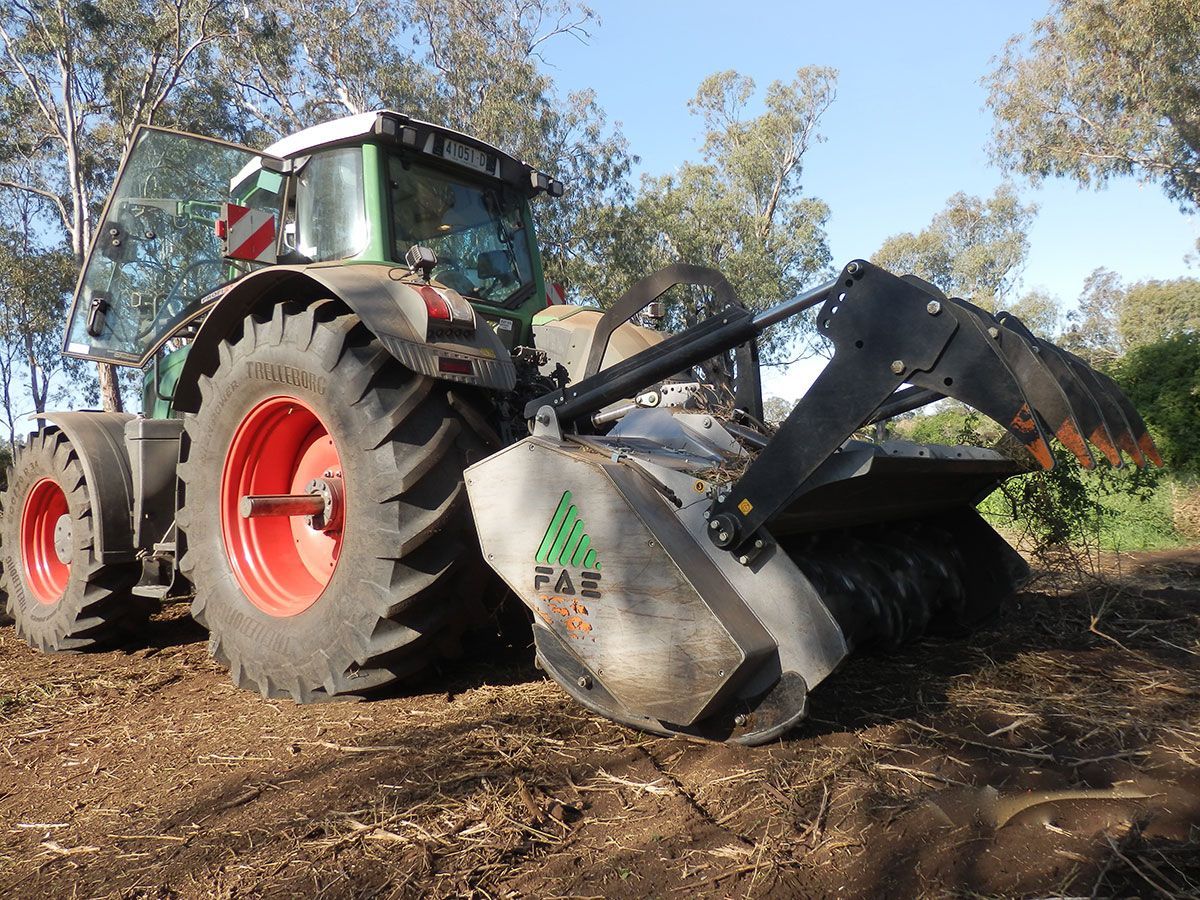 A faz tractor is parked in a dirt field