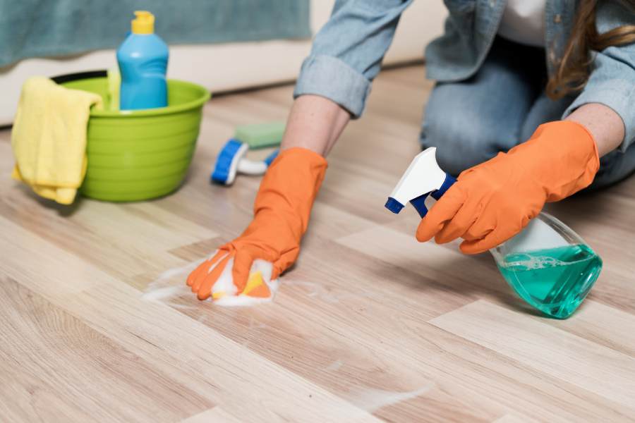 woman-with-rubber-gloves-cleaning-floors
