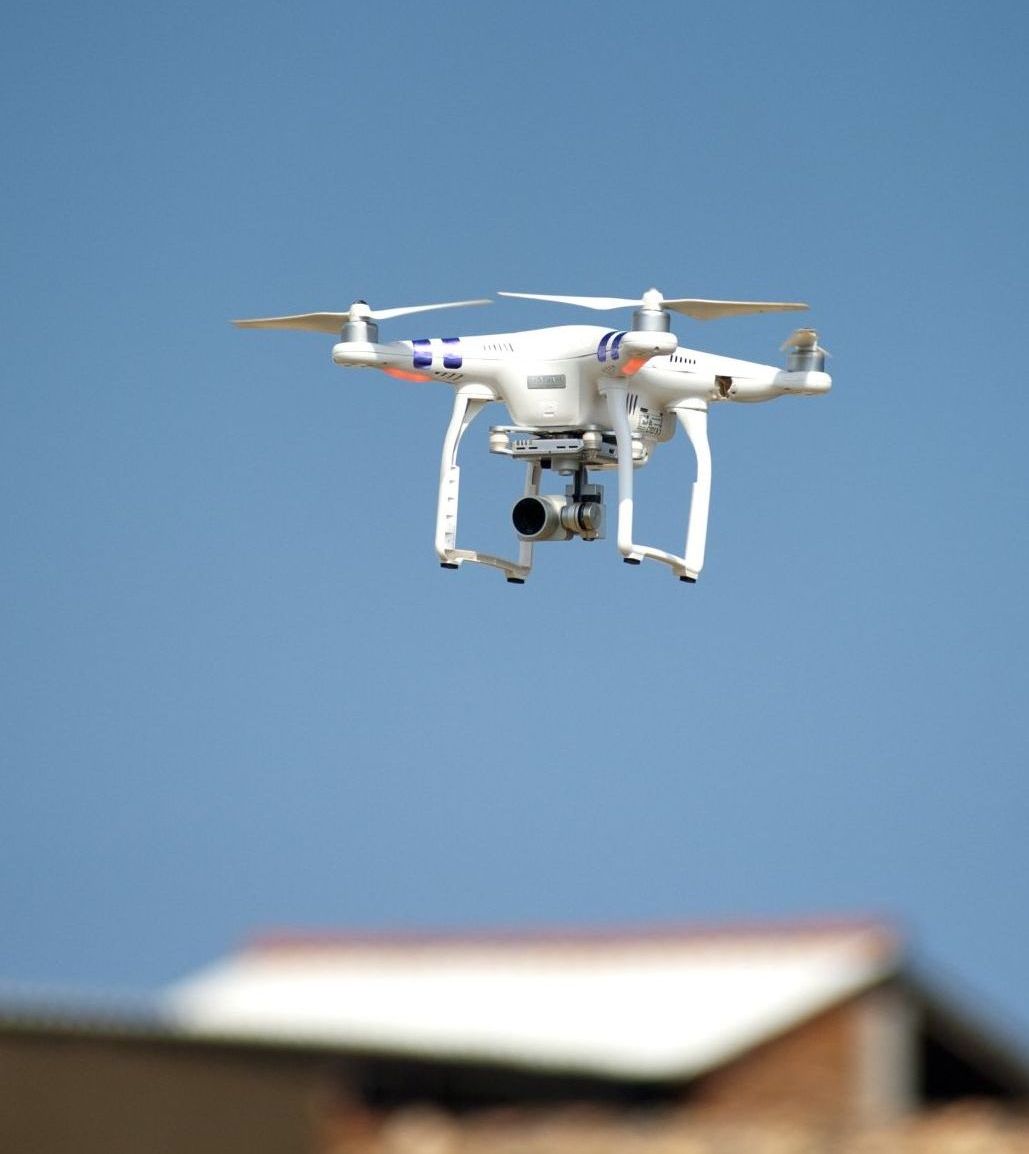 A drone is flying over a brick building