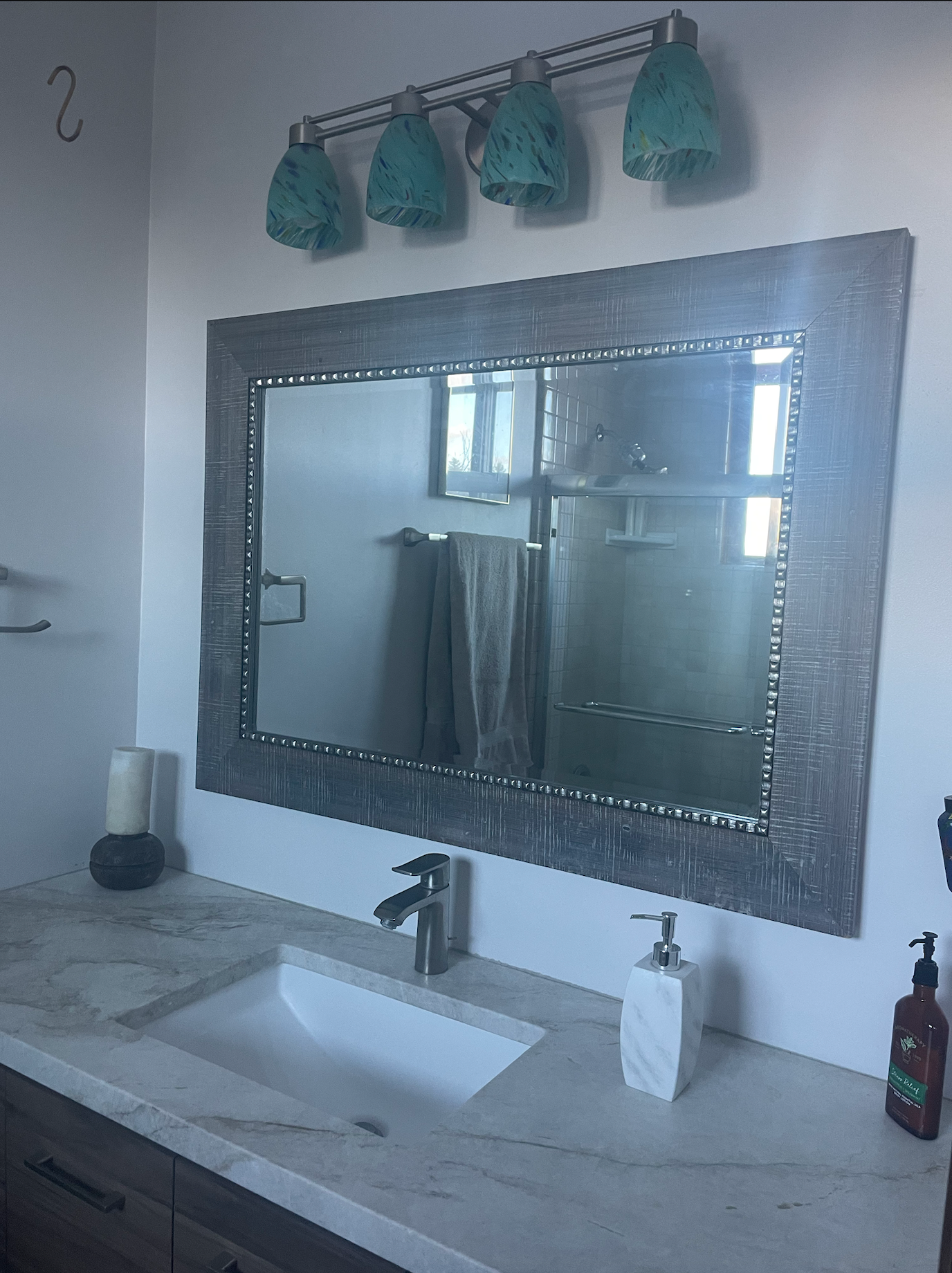 A bathroom with a sink and a large mirror