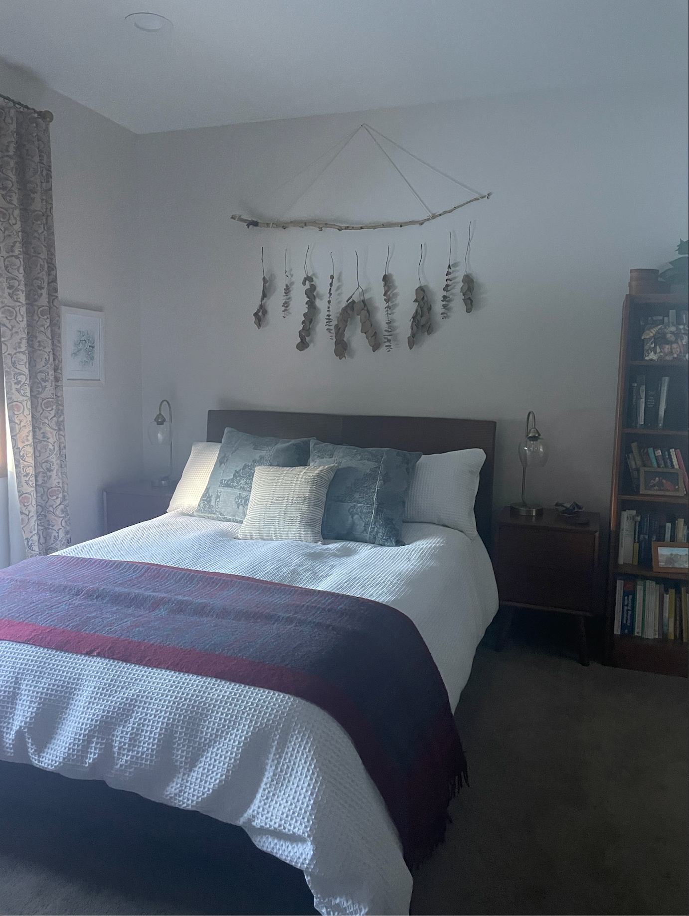 A bedroom with a bed and a bookshelf