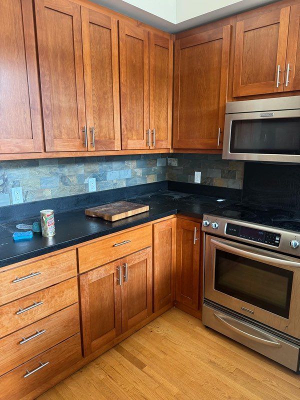 A kitchen with wooden cabinets and stainless steel appliances