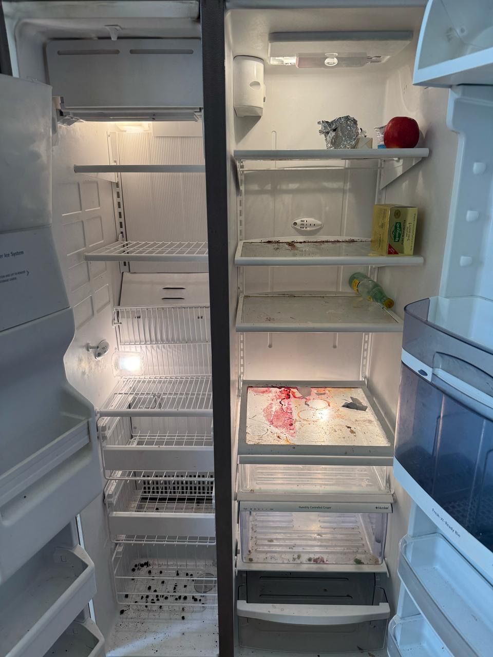The inside of an empty refrigerator with the door open