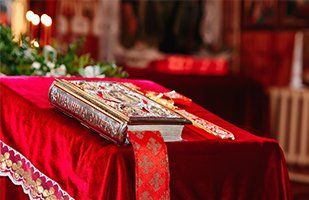 Vestment — Holy Bible Prepared for Christening in Metairie, LA