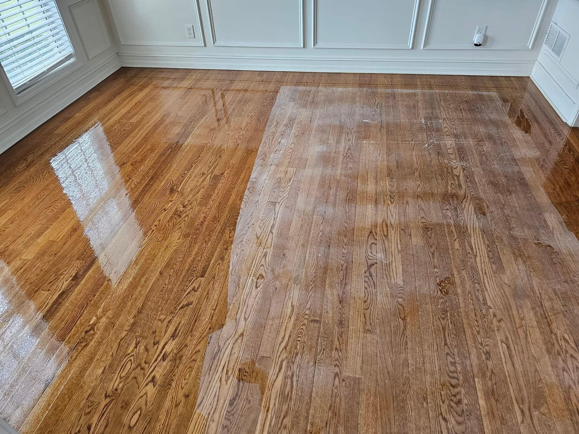 A wooden floor with a rug on it in a room.