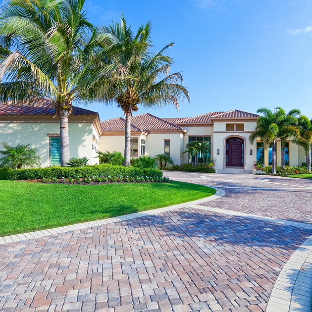A large house with palm trees in front of it