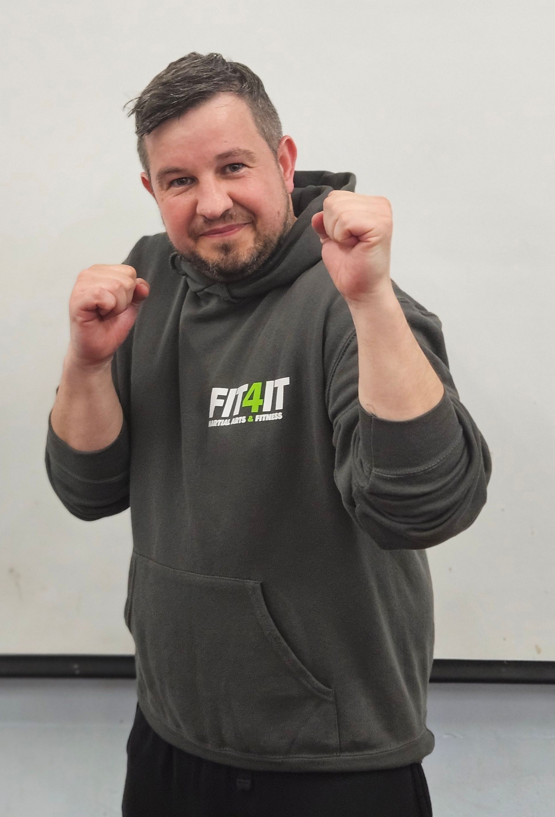 man with grey hoodie in combat pose