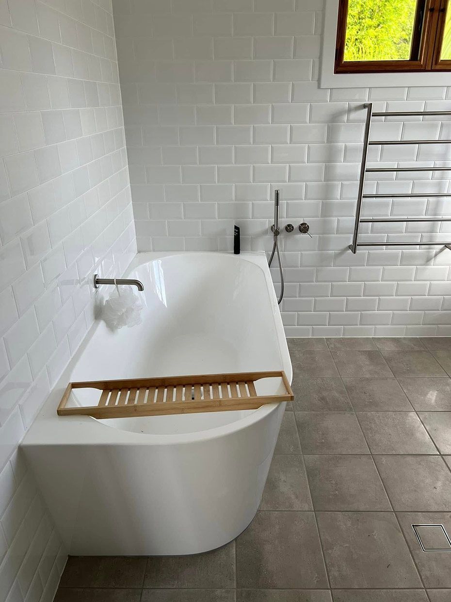 A Bathroom With a Bathtub and a Window — Etosha Plumbing & Gasfitting In Alstonville, NSW