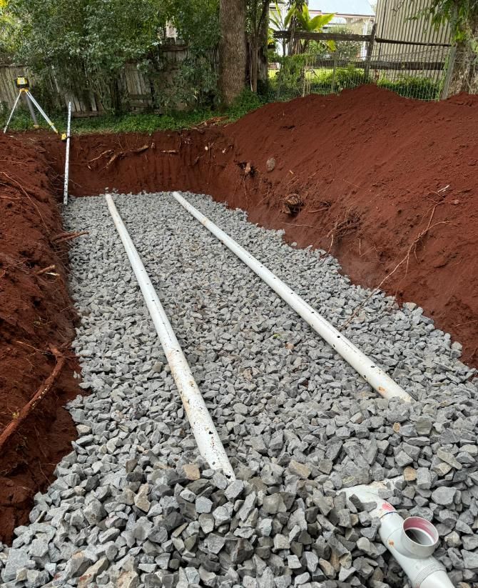 A Trench Filled With Rocks And Pipes Is Being Built — Etosha Plumbing & Gasfitting In Alstonville, NSW