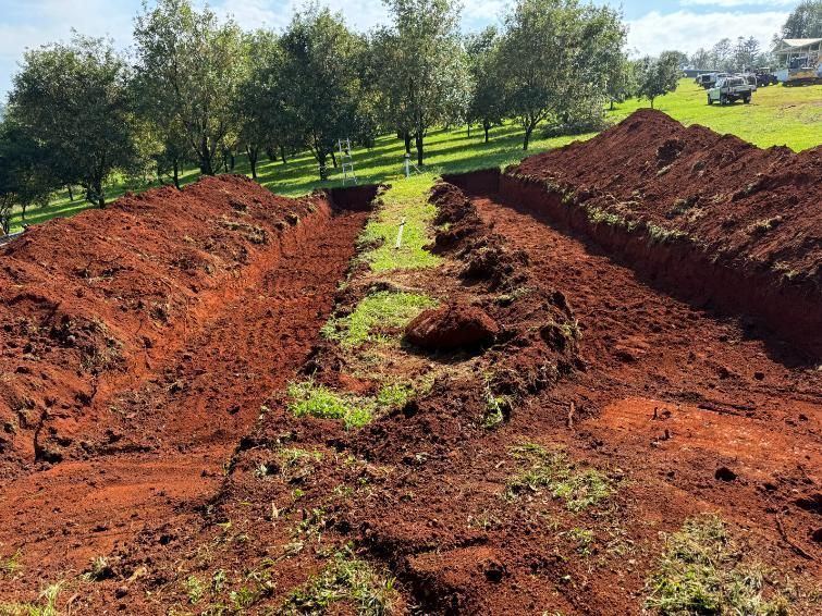 A Large Pile Of Dirt Is Sitting In The Middle Of A Field — Etosha Plumbing & Gasfitting In Alstonville, NSW