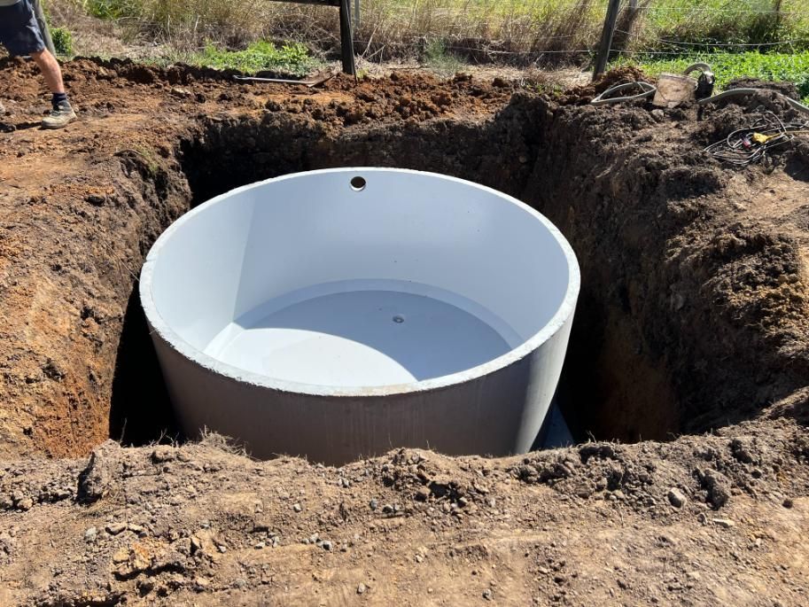 A Large Concrete Cylinder Is In A Hole In The Ground — Etosha Plumbing & Gasfitting In Ballina, NSW