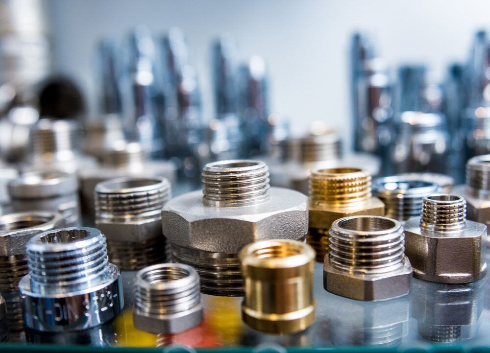 There Are Many Different Types Of Metal Fittings On The Table — Etosha Plumbing & Gasfitting In Bangalow, NSW