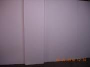 Blank white wall with a narrow vertical panel and a small digital timestamp in the corner