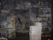 Dark, blurry interior with a person-shaped figure at center and stacked white blocks in the foreground
