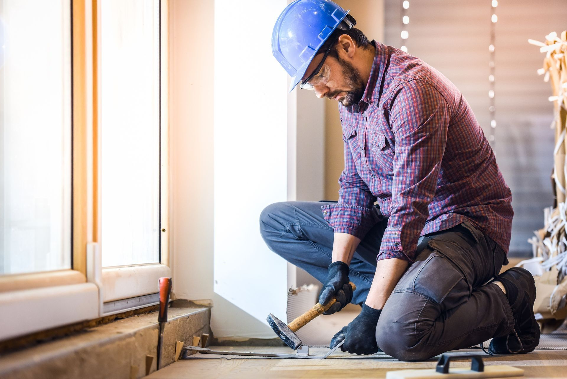 Worker repairing subfloor as part of a home foundation repair project.