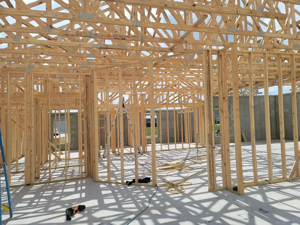 A house is being built with a lot of wooden beams.