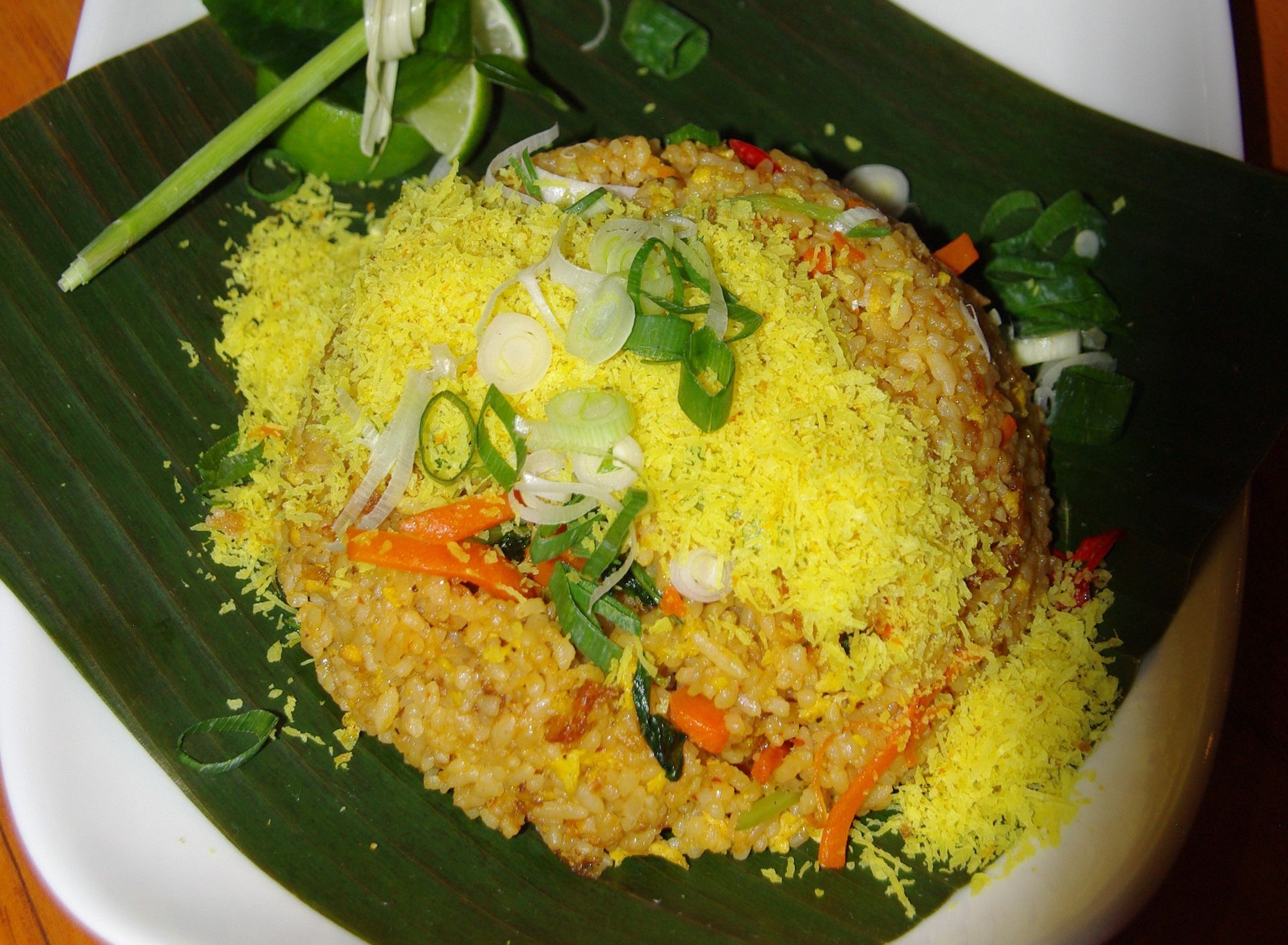 A close up of a plate of food on a banana leaf
