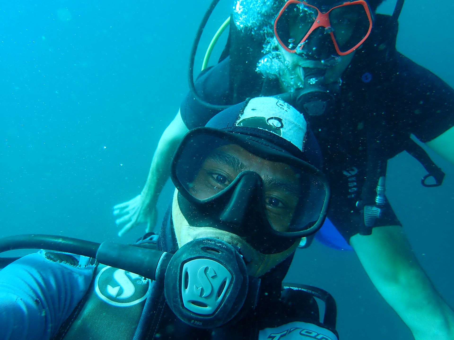 Two scuba divers are taking a selfie in the ocean
