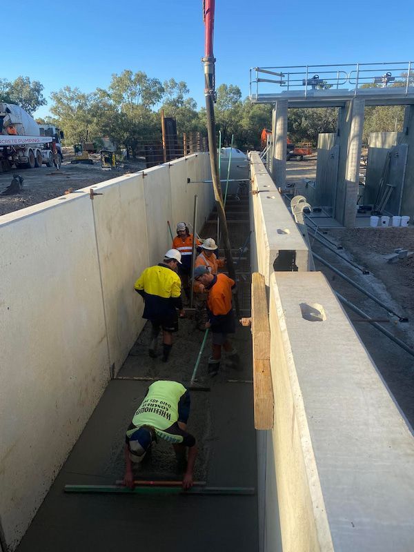 A Group of Construction Workers Are Working on A Concrete Wall — Maslin Concrete Pumping in Forbes, NSW