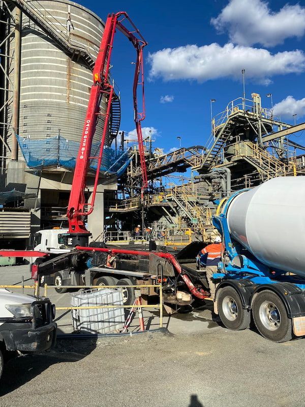 A Concrete Mixer Is Being Used to Pump Concrete Into a Building — Maslin Concrete Pumping in Condobolin, NSW