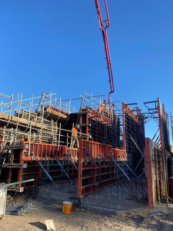 A Concrete Pump Is Being Used to Pour Concrete Into a Building Under Construction — Maslin Concrete Pumping in Forbes, NSW
