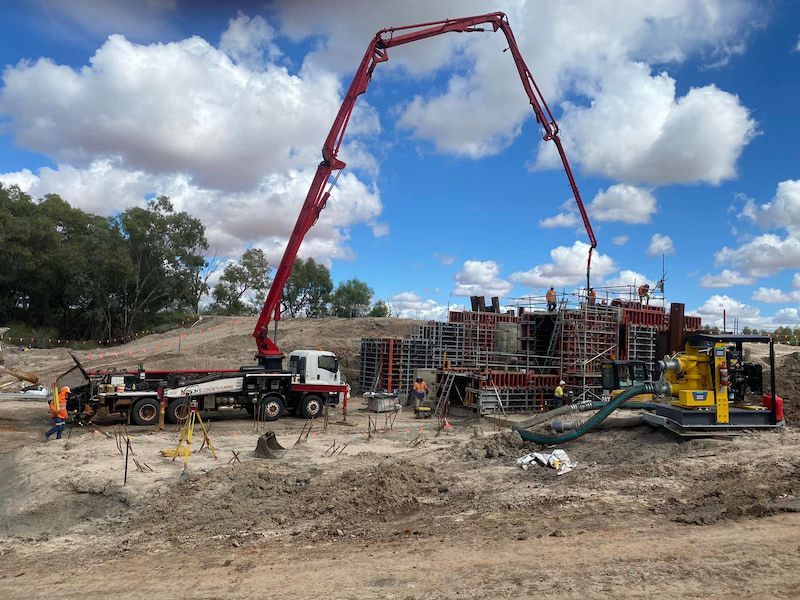 A Concrete Pump Is Being Used to Pour Concrete on A Construction Site — Maslin Concrete Pumping in Forbes, NSW