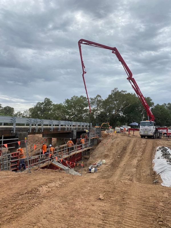 A Concrete Pump Is Being Used to Pour Concrete on A Bridge Under Construction — Maslin Concrete Pumping in Parkes, NSW
