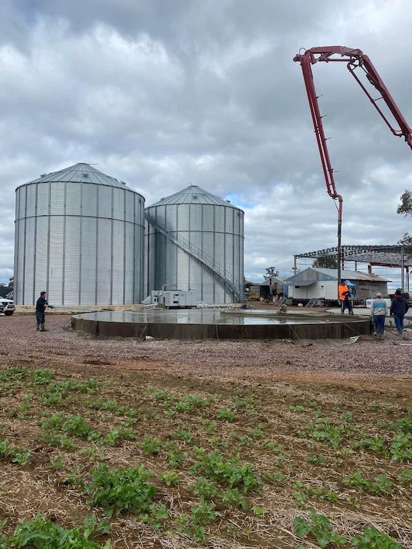 A Group of Silos Are Being Built in A Field — Maslin Concrete Pumping in Forbes, NSW