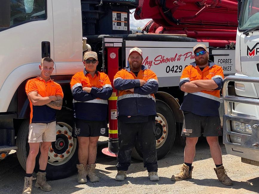 A Group of Men Are Posing for A Picture in Front of A Truck — Maslin Concrete Pumping in Forbes, NSW