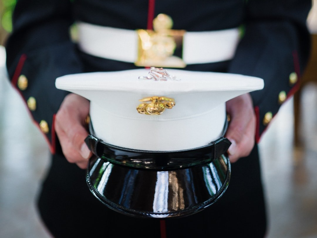 Soldier holding military cap