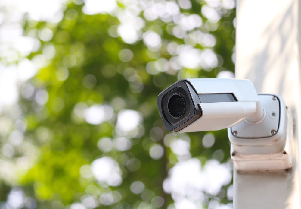 A White Security Camera Mounted on a Post — OHMY Electrical Contractors in Carina, QLD