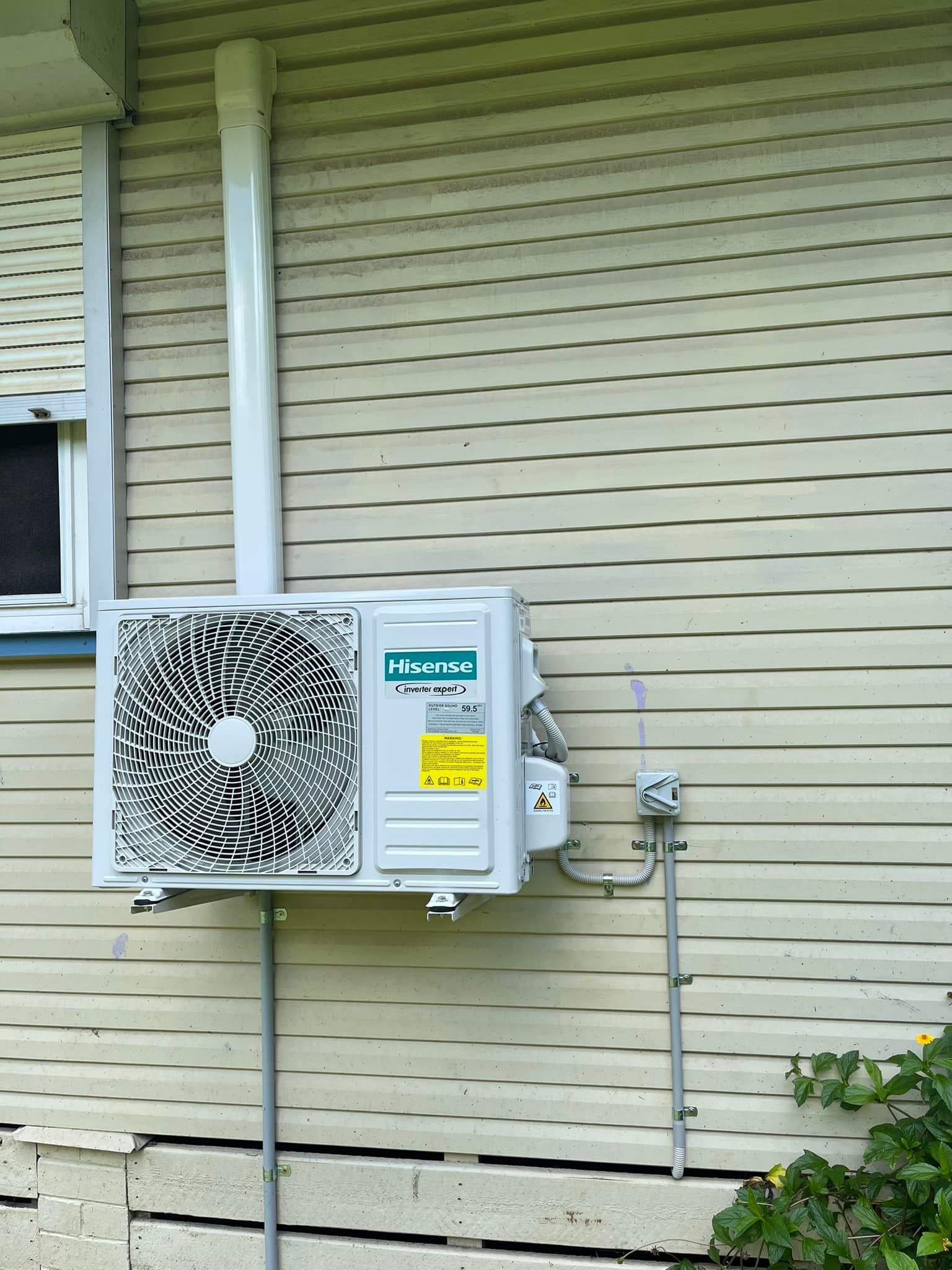A White Outdoor Mini-split Ac Unit Mounted on the Light-coloured Wood — OHMY Electrical Contractors in Carina, QLD
