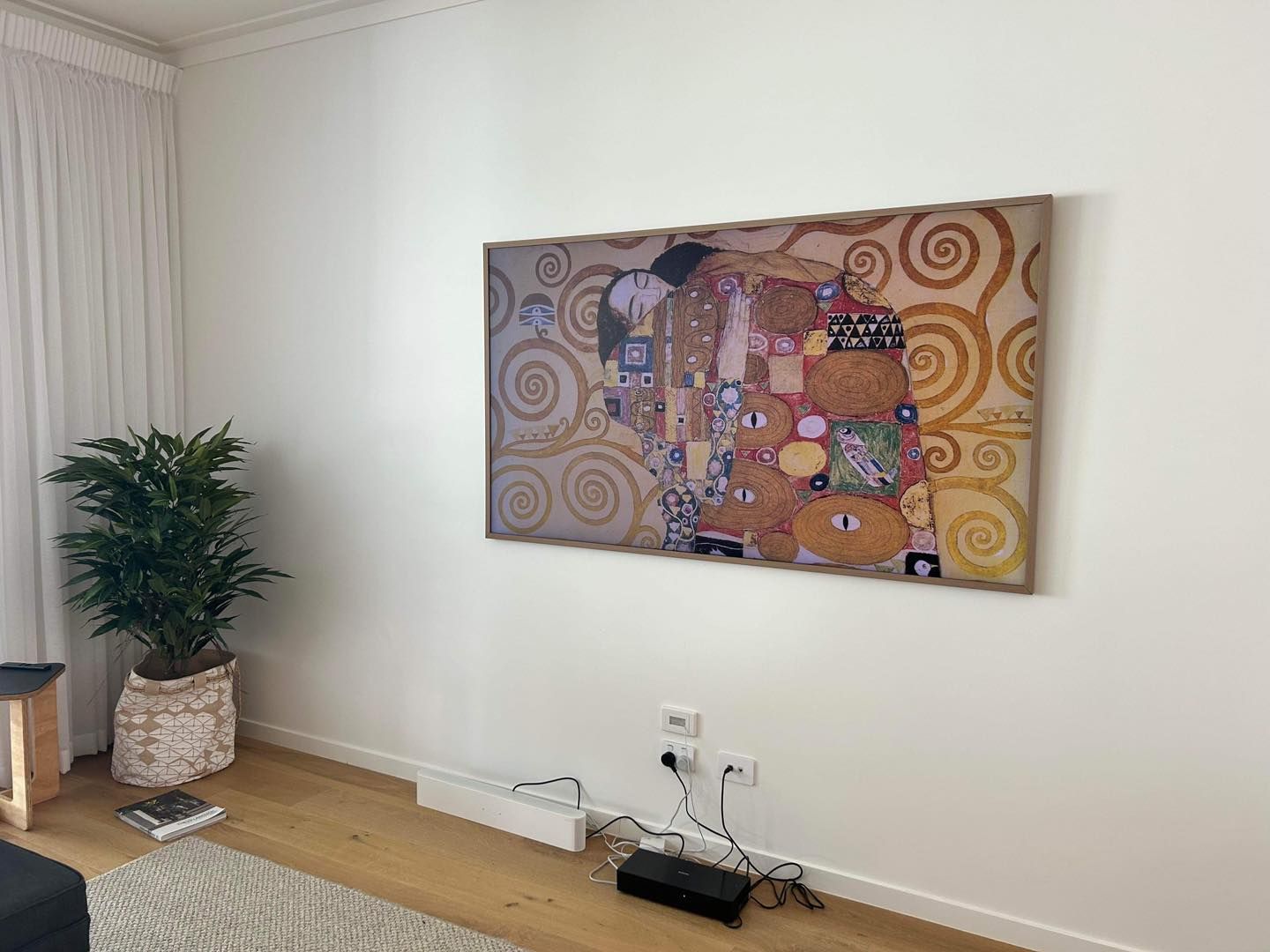 A Large Print of Gustav Klimt's the Kiss Hangs on a White Wall — OHMY Electrical Contractors in Carina, QLD