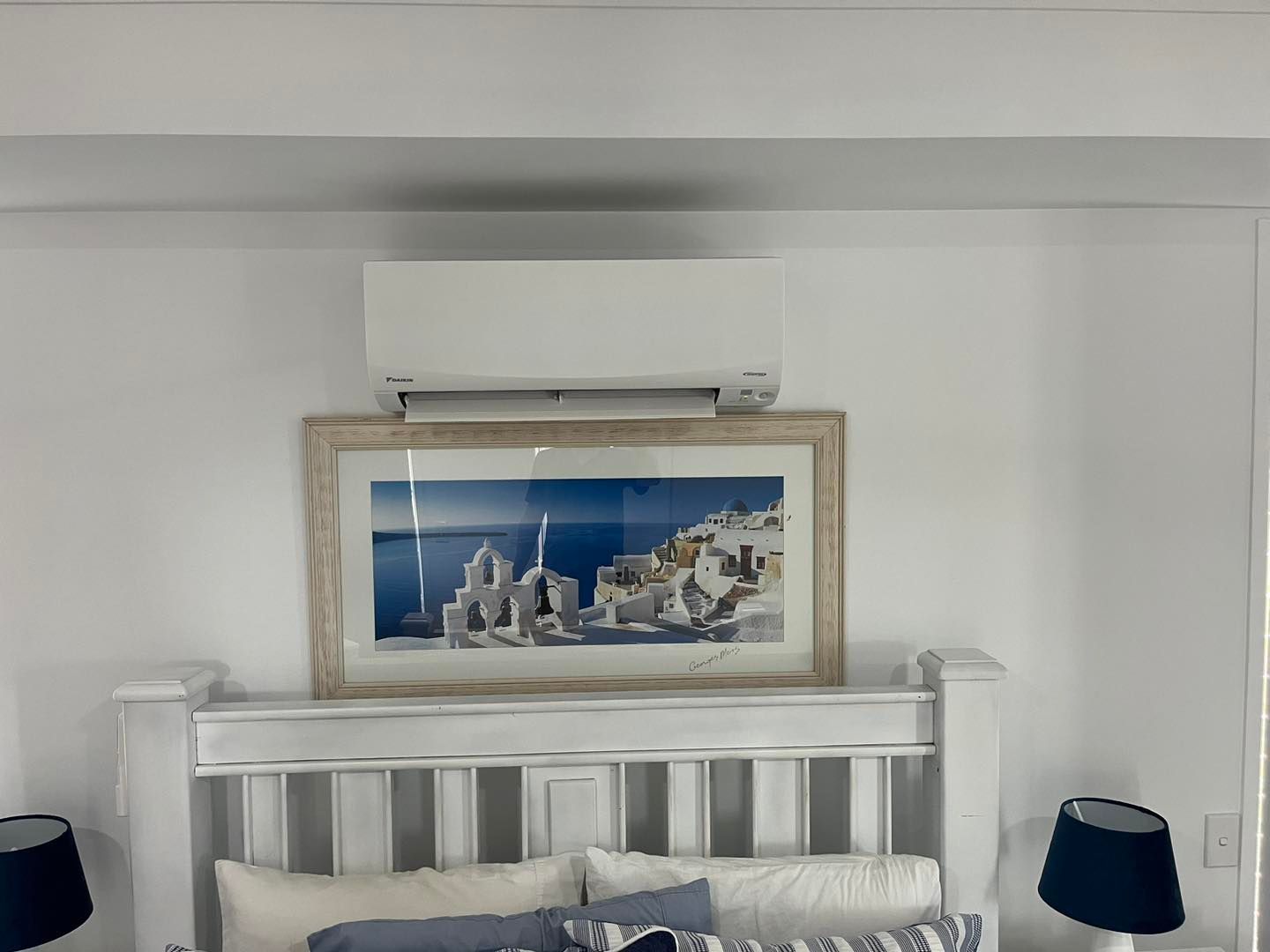 A Bedroom Featuring a Bed With a White Headboard and an Split Type AC — OHMY Electrical Contractors in Carina, QLD