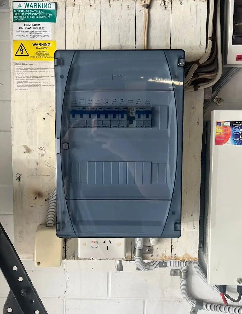Gray Electrical Breaker Panel Mounted on a Cinderblock Wall — OHMY Electrical Contractors in Carina, QLD