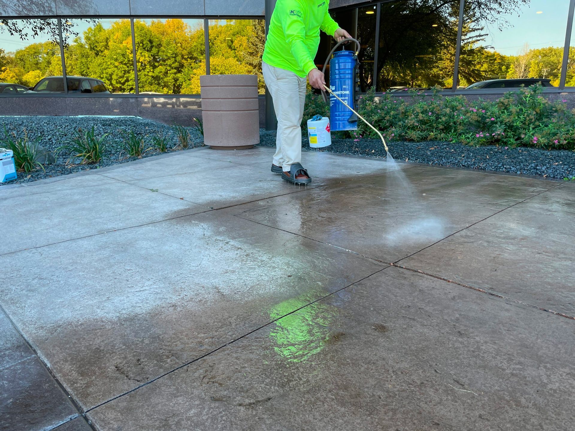 A man is cleaning a brick roof with a high pressure washer.