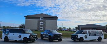 A man wearing a black t-shirt and cap, with text