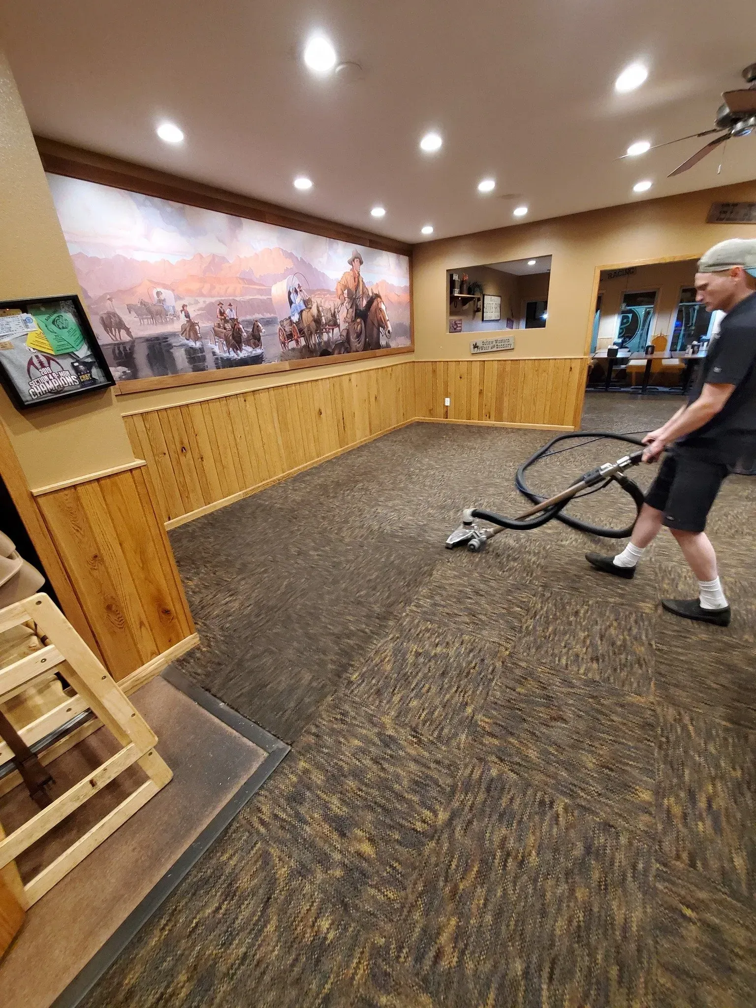 A man is pulling a rope in a gym.