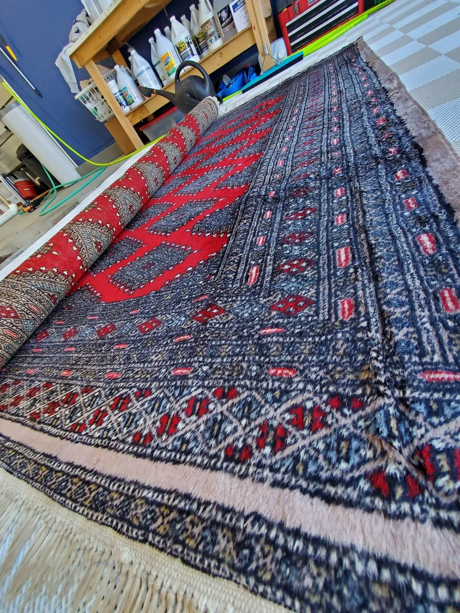 A rug is sitting on top of a wooden floor in a room.