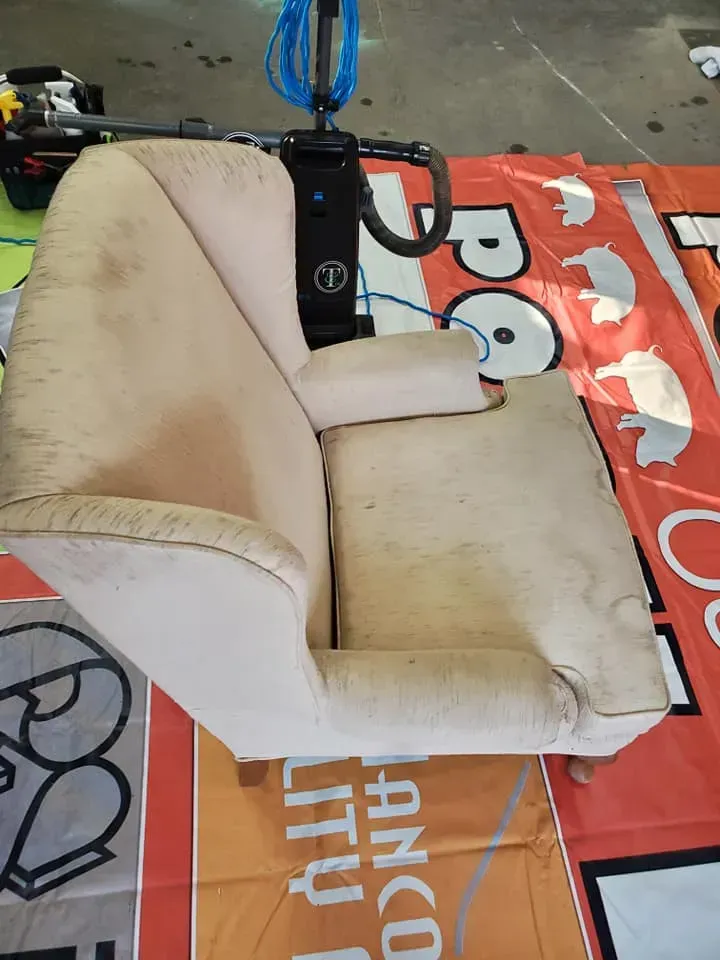 A chair is sitting on top of a blanket that says utility