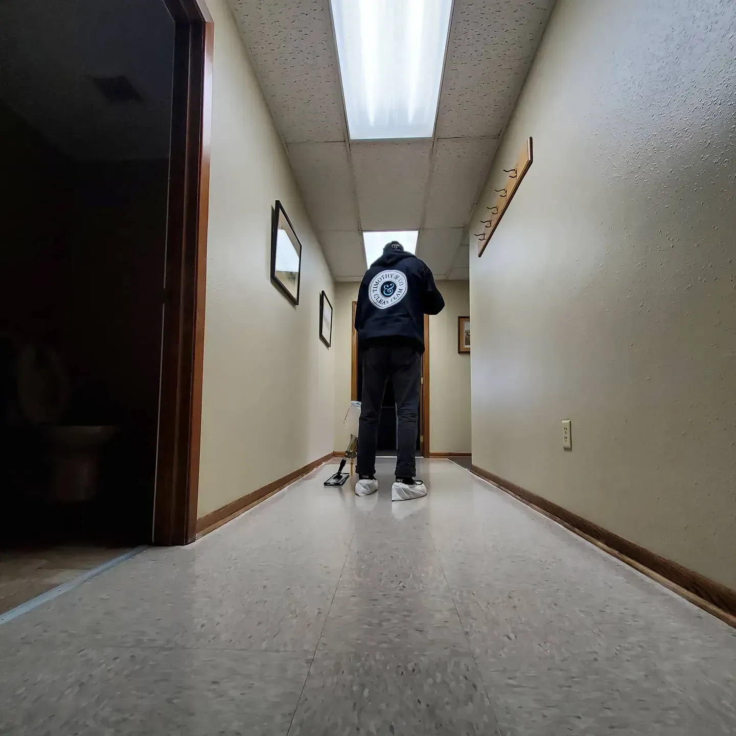 A person walking down a hallway with a circle on their back